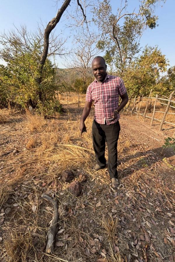 Samba pointing to where he’s been told there is water. This is where he will dig the well. Snowboarding